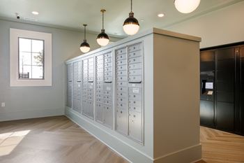 A row of mailboxes are lined up on a wall.